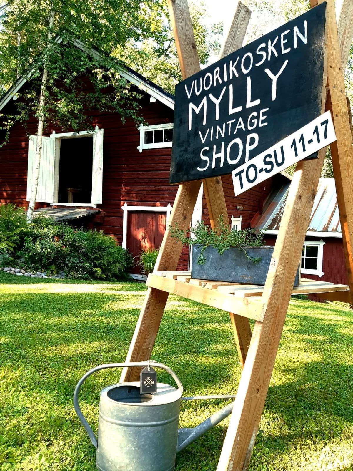 The Vuorikosken Mylly sign in the yard: Vintage Shop Thu–Sun 11–17